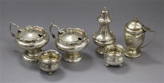 Six assorted silver condiments, including mustards and salts.